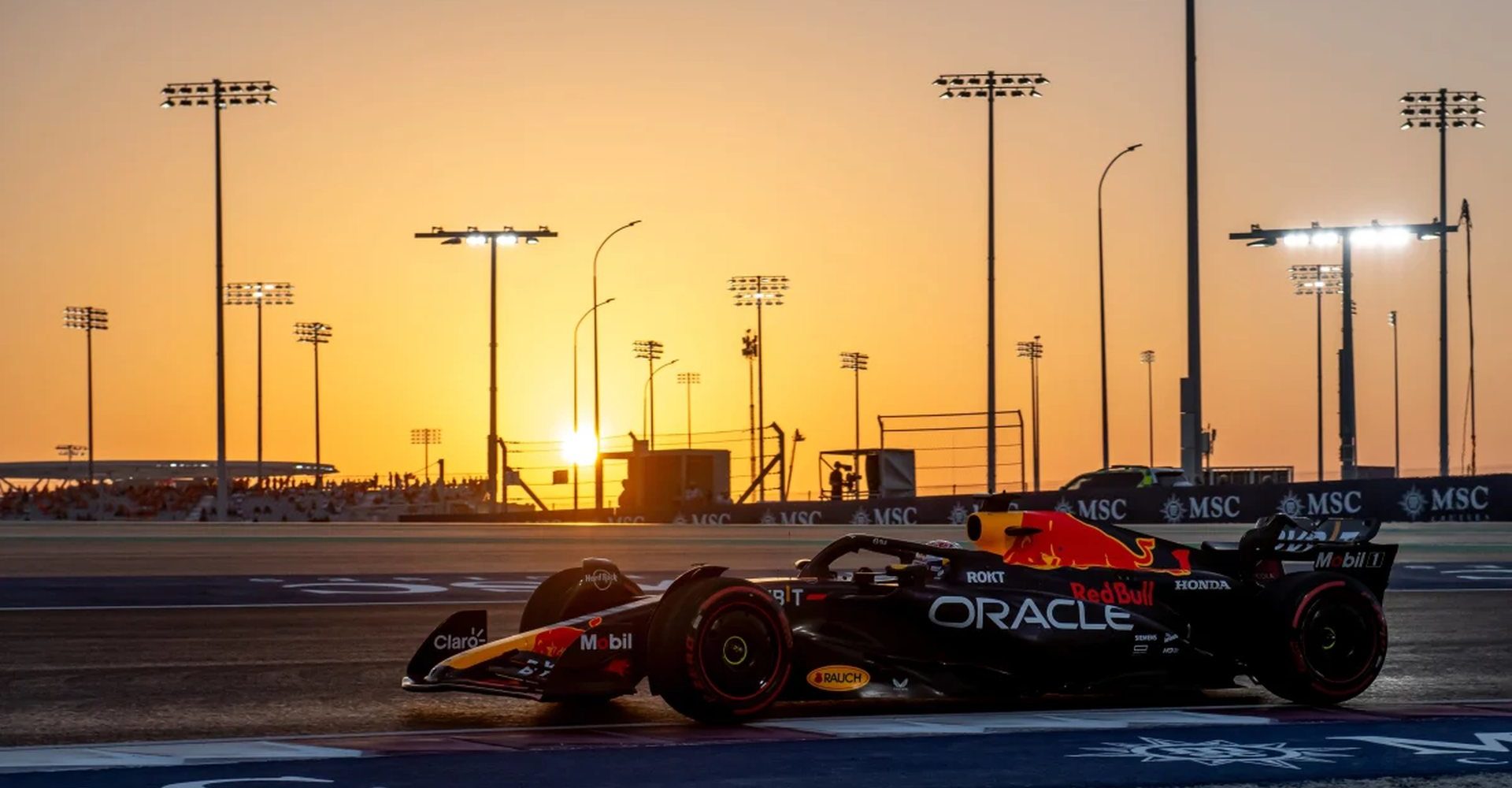 Formula 1 car on track at sunset