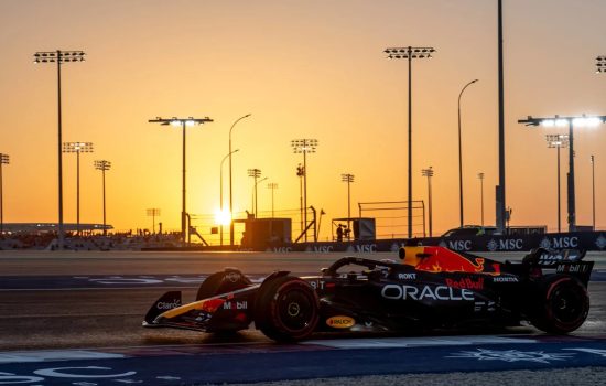 Formula 1 car on track at sunset