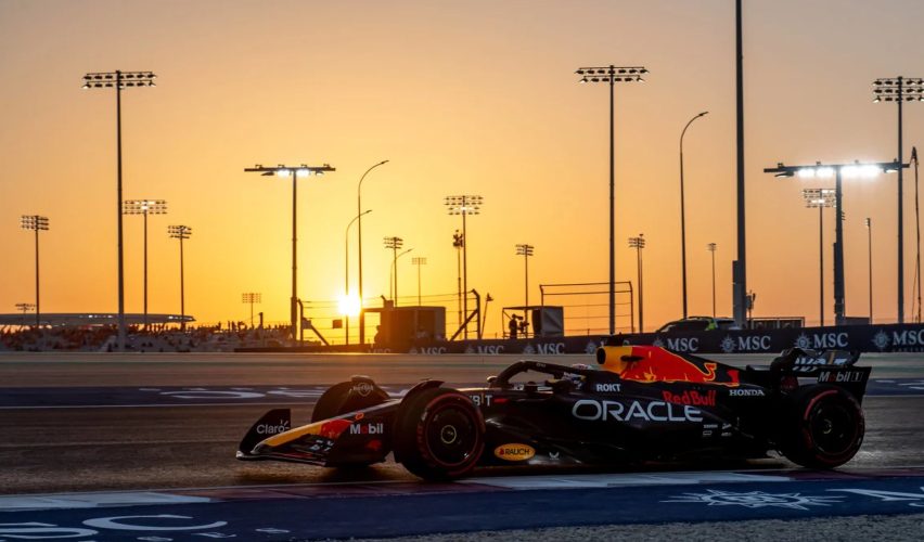 Formula 1 car on track at sunset