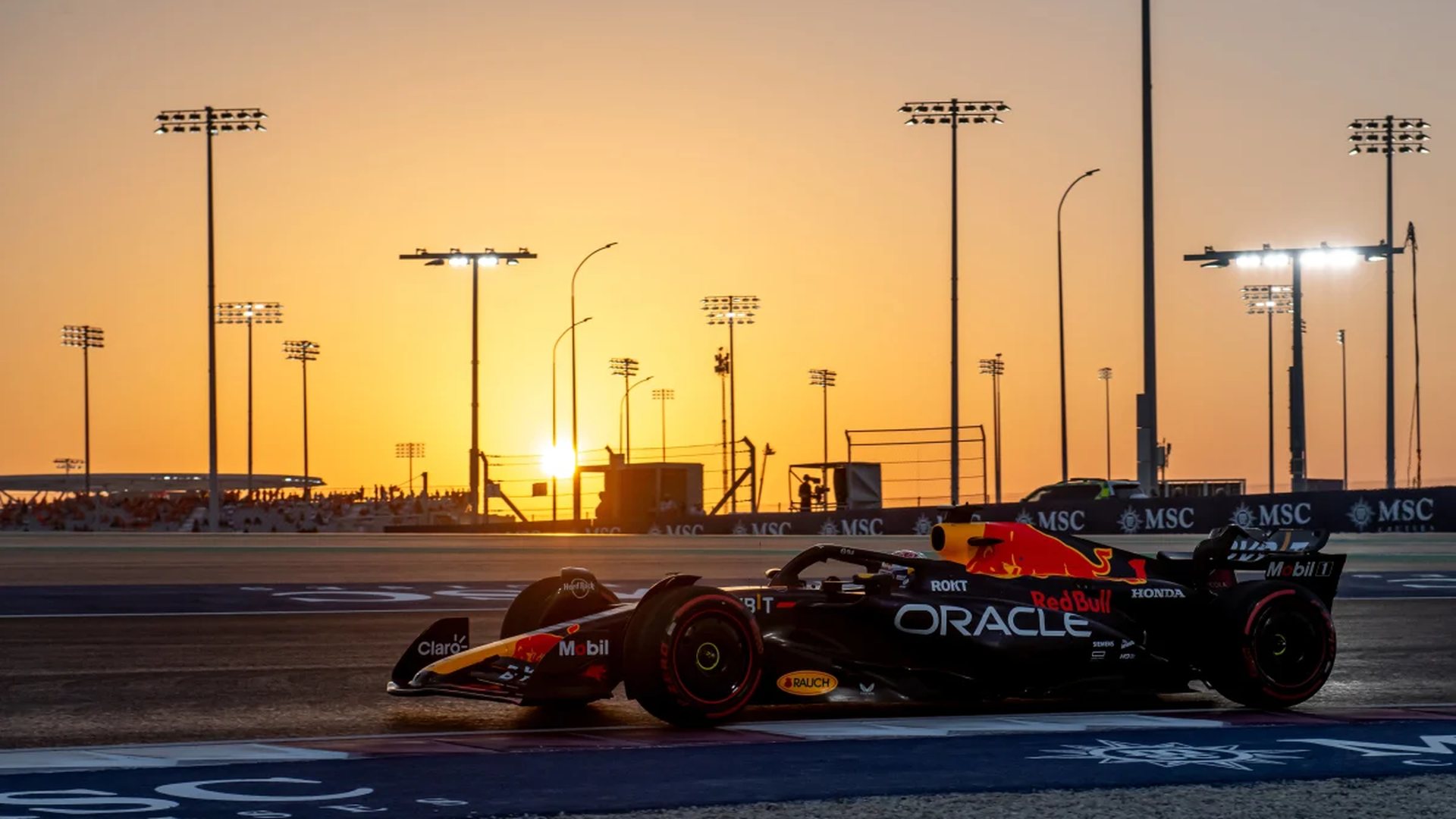 Formula 1 car on track at sunset