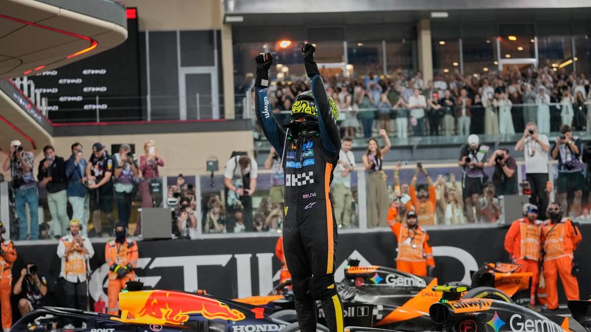 Driver celebrating on the podium in front of the crowd