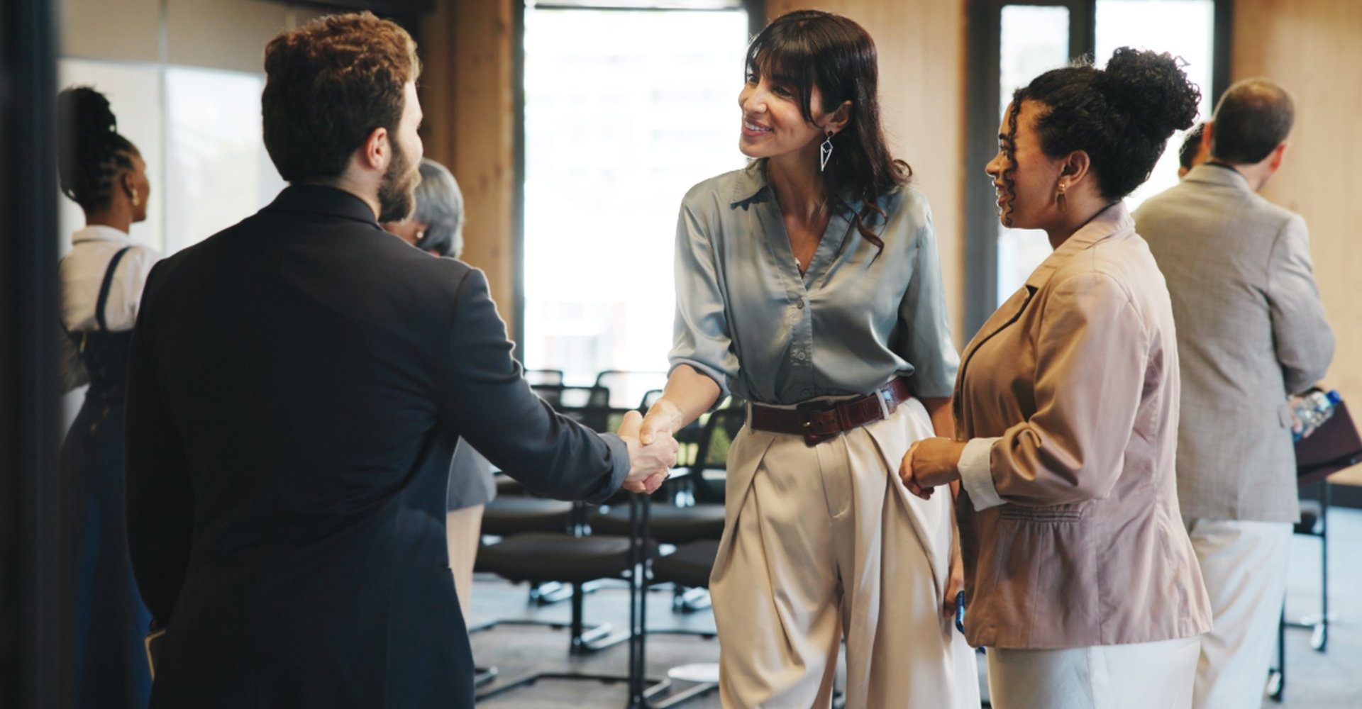 Delegates shaking hands at a business event in Malaysia