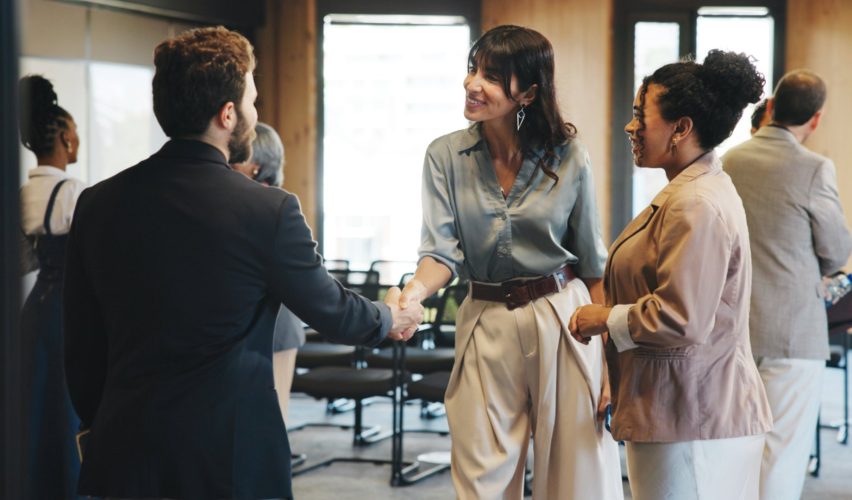 Delegates shaking hands at a business event in Malaysia