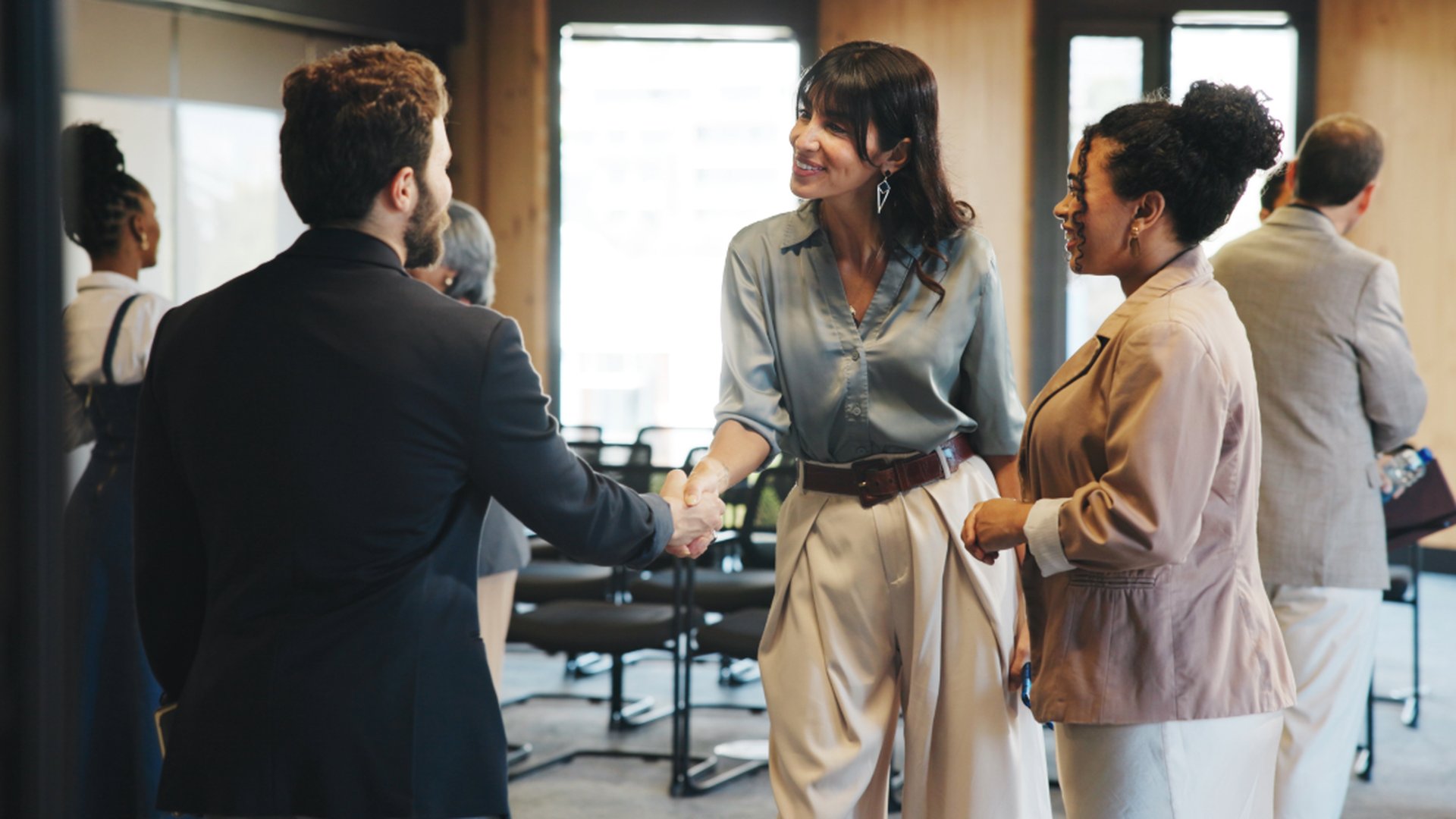 Delegates shaking hands at a business event in Malaysia